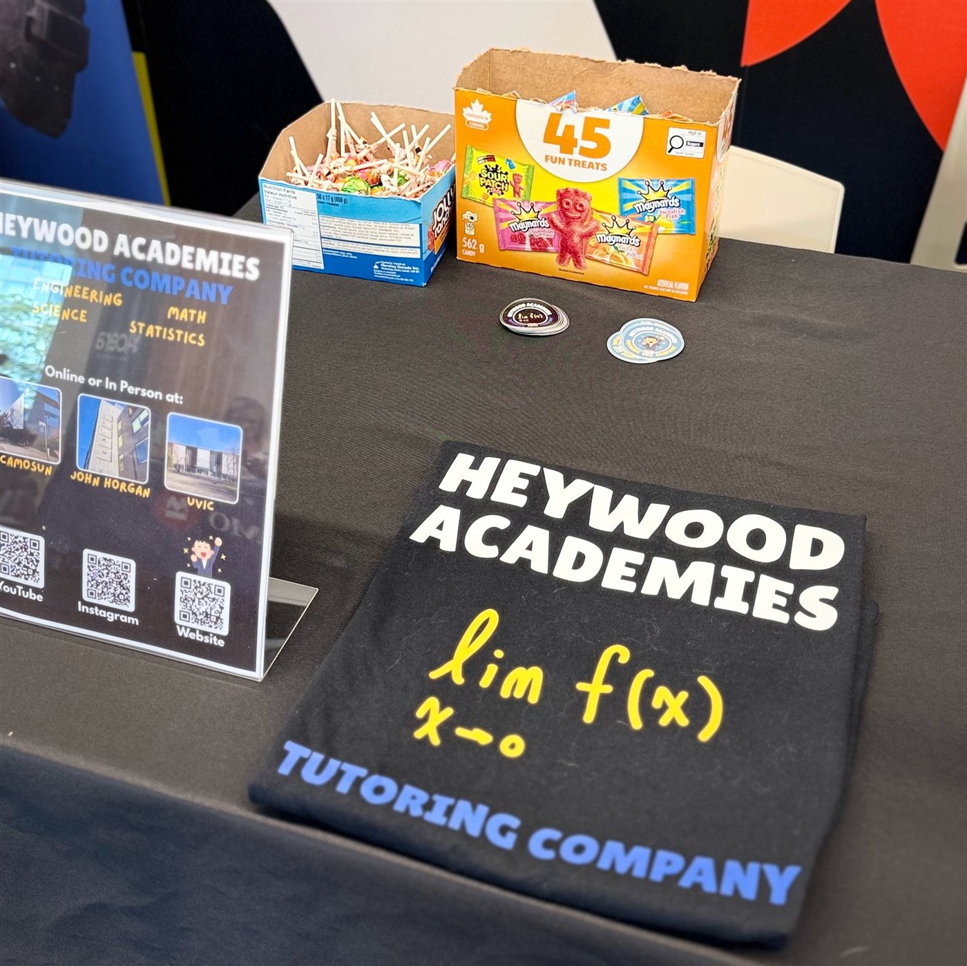 Candy and stickers laid out on the Heywood Academies booth table