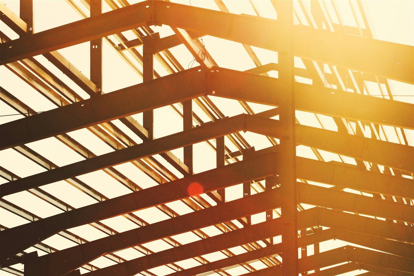 Steel roof beam structure lit by sunlight